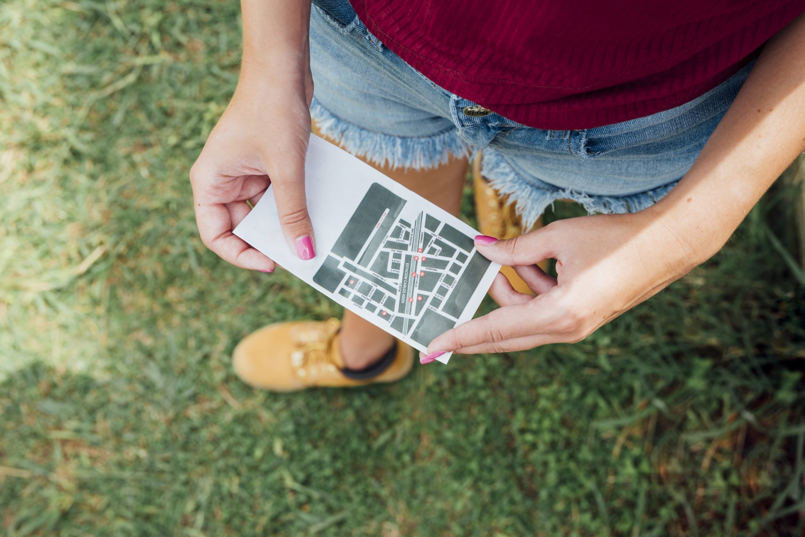 top-view-woman-holding-directions-card